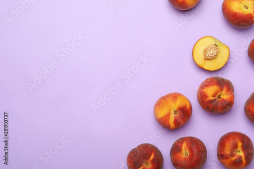 Sweet juicy peaches on lilac background, top view. Space for text