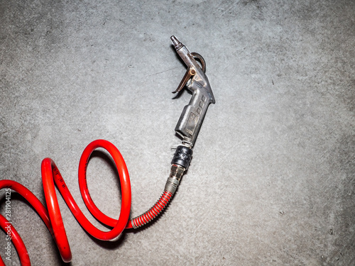 metal gun and red tube for compressed air system for cleaning mechanical parts