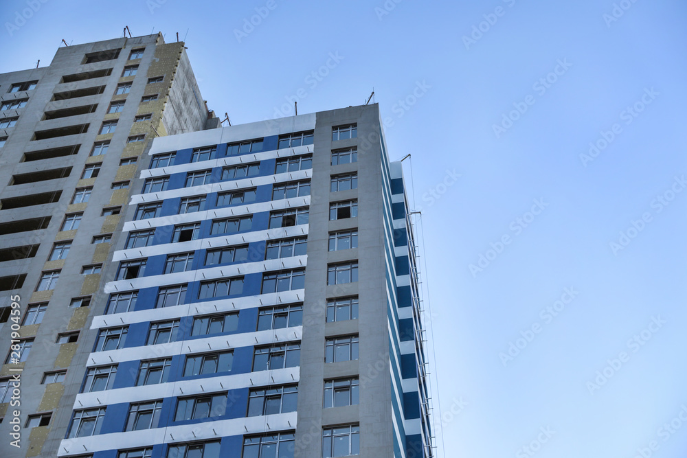 Unfinished building against blue sky. Space for text