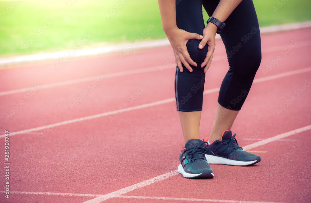 Female runner knee injury and pain on running track,Injury from workout concept Female runner knee injury and pain on running track,Injury from workout concept
