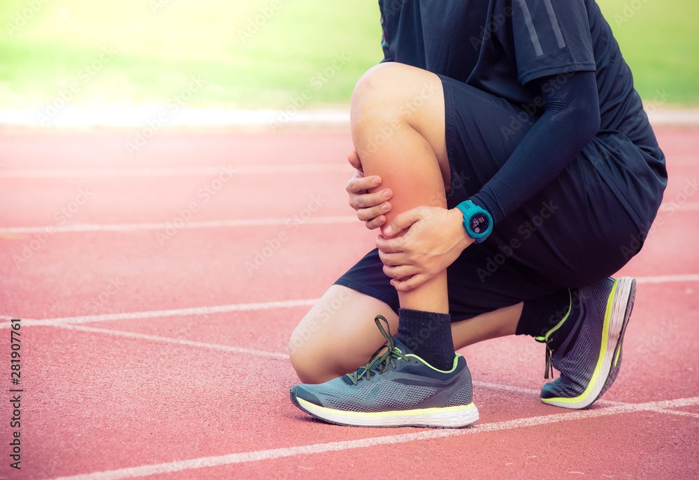 Male runner shin bone injury and pain on running track,Injury from