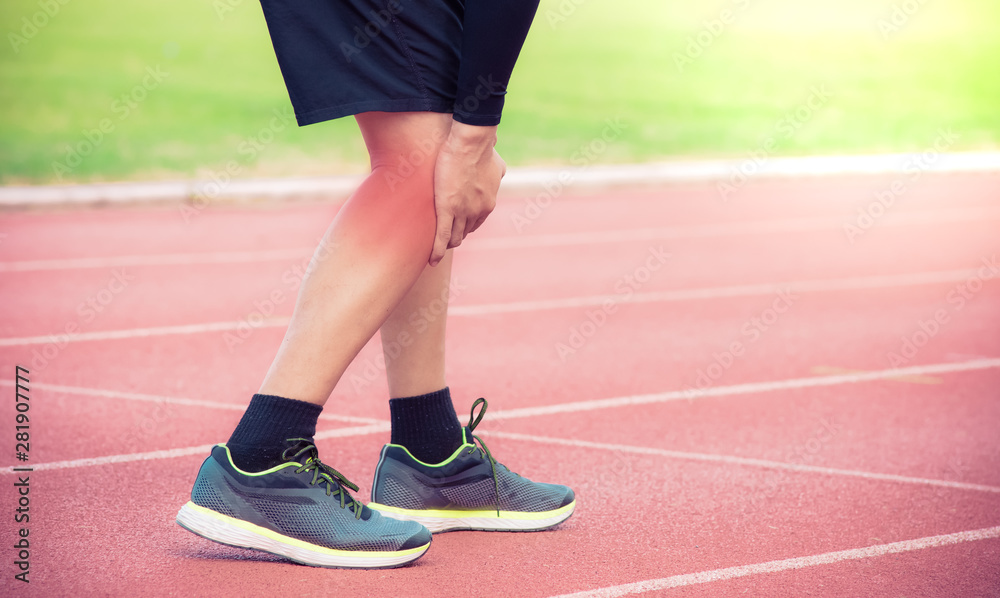 Male runner knee injury and pain on running track,Injury from workout concept