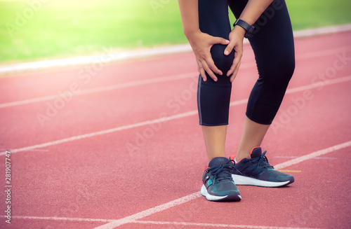 Female runner knee injury and pain on running track,Injury from workout concept