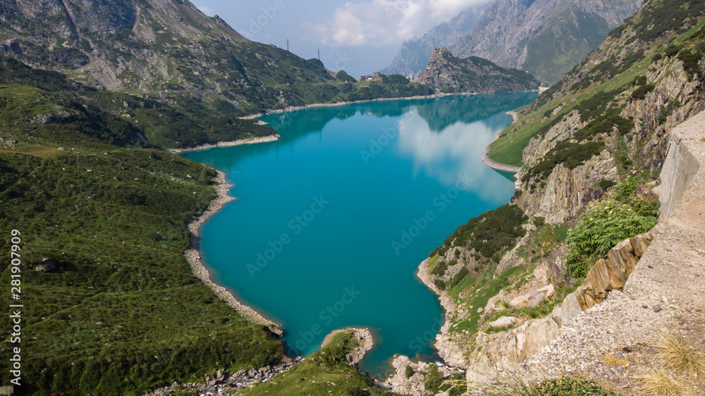 Landscape of the Lake Barbellino an alpine artificial lake. Turquoise water. Italian Alps. Italy. Orobie. Lake from which the Serio river is born. Summer time