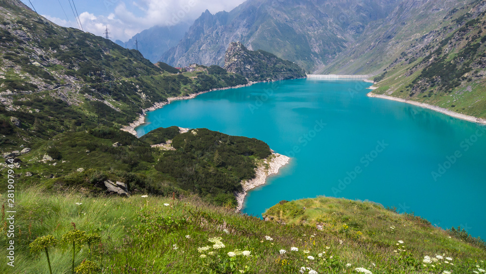Landscape of the Lake Barbellino an alpine artificial lake. Turquoise water. Italian Alps. Italy. Orobie. Lake from which the Serio river is born. Summer time