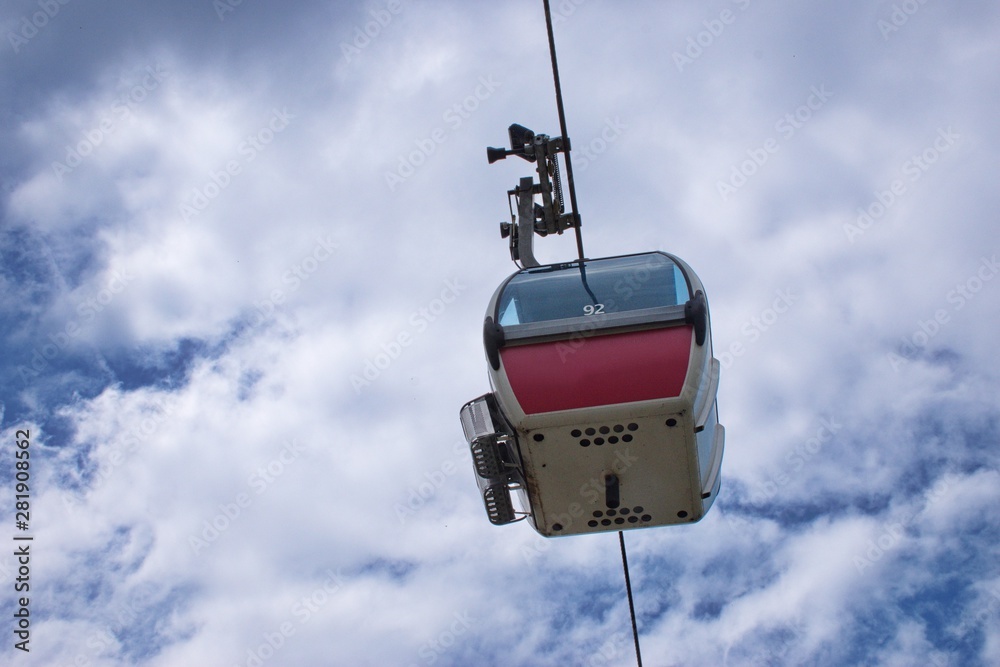 Low angle view of cable car against the cloudy sky Low angle view of cable car against the cloudy sky