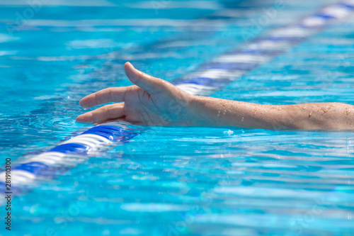 Man's hand in pool water