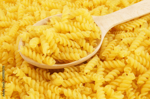 Macaroni background with wooden spoon