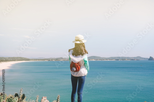 Back view of young woman look at the sea of Phu Yen beach, Vietnam.