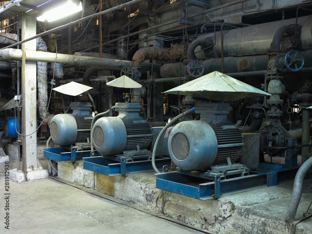 Industrial big water pumps with electric motors, pipes, tubes, equipment and steam turbine at power plant
