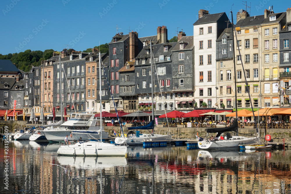 HONFLEUR, FRANCE - July 29, 2019: sailboats and pleasure boats are anchored in the port of Honfleur, France