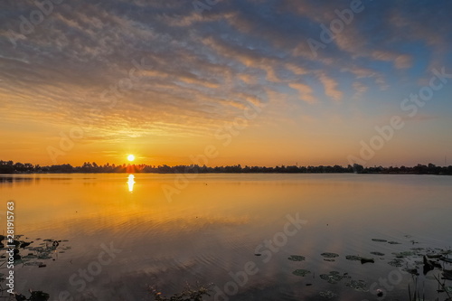 Lake view morning of yellow sun light and cloudy sky background  sunrise at Krajub reservoir  Ban Pong District  Ratchaburi  Thailand.