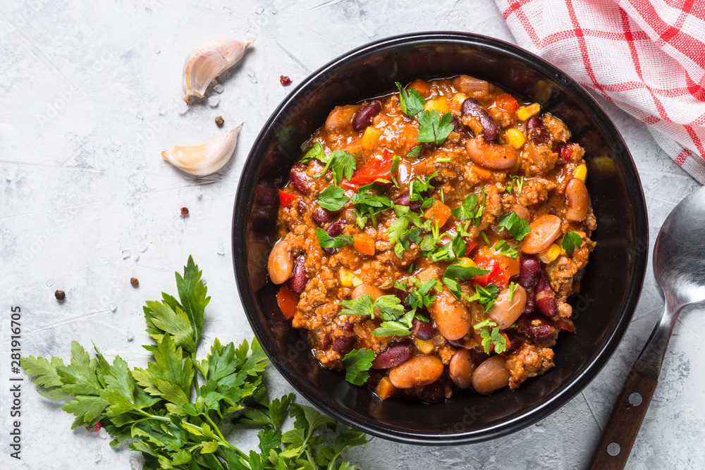 Chili con carne from meat and vegetables on stone table top view. Chili con carne from meat and vegetables on stone table top view.
