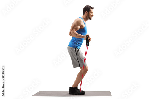 Man on an exercise mat with a resistance band photo