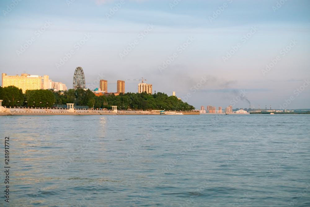 View of the city of Khabarovsk from the Amur river. Urban landscape in the evening at sunset.