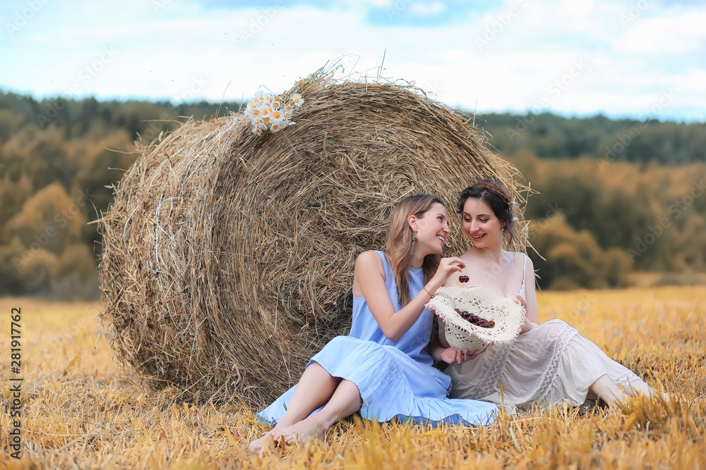 Two girls in dresses in autumn field Two girls in dresses in autumn field
