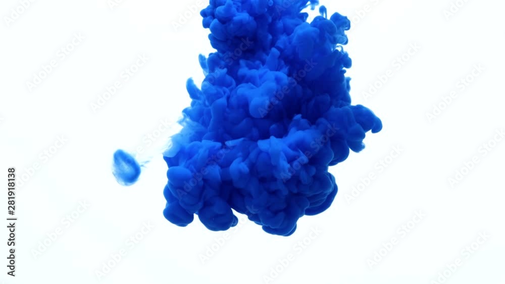 Blue color paint ink drops in water slow motion video with copy space. Inky cloud swirling flowing underwater. Abstract isolated smoke explosion