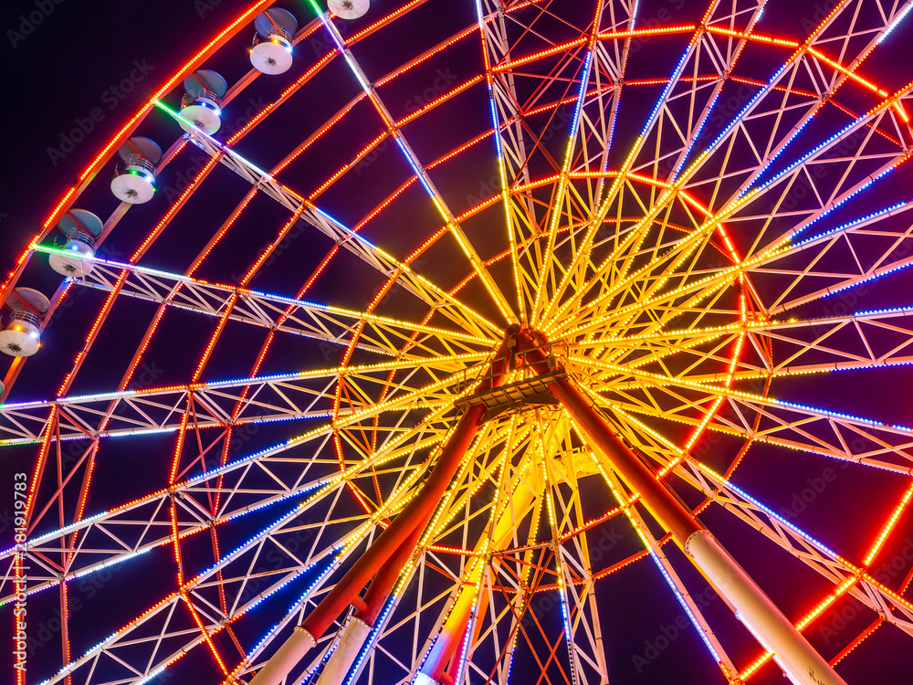 Ferris wheel beautifully glowing at night.