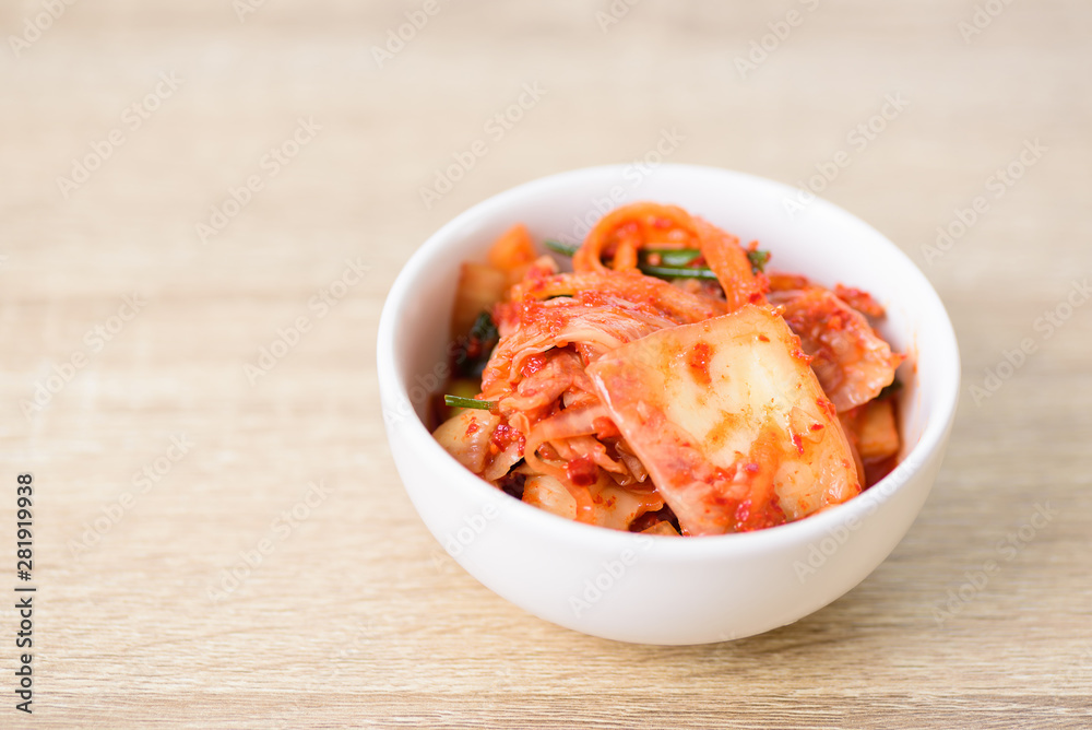 Kimchi cabbage in a bowl on wooden background, Korean food Kimchi cabbage in a bowl on wooden background, Korean food