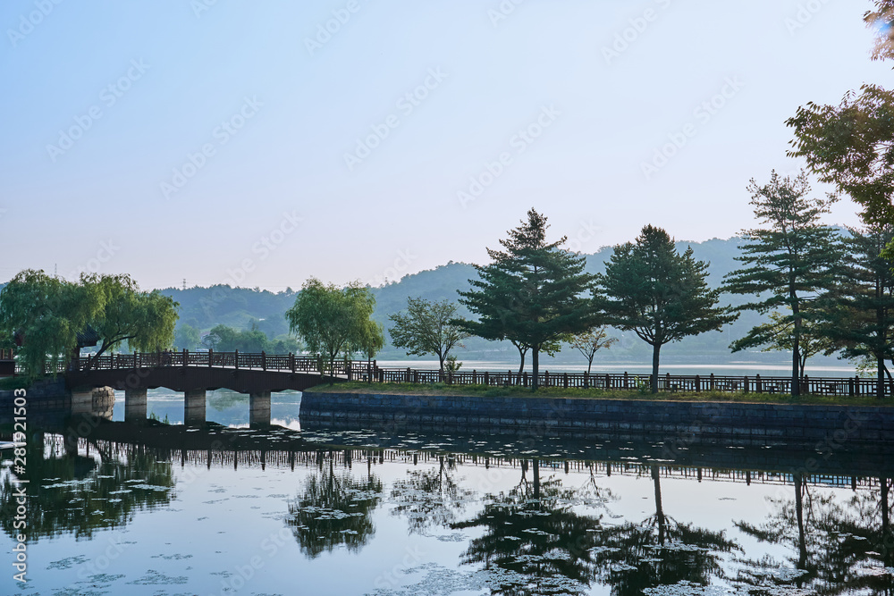 The reflection of the trees and wooden bridge at the Uirimji Reservoir in Jechun, South Korea.