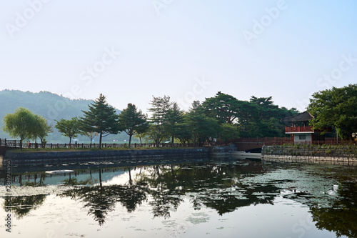 A view of the reflection of a gazebo and the trees at Uirimji Reservoir in Jechun, South Korea. © JinHyun