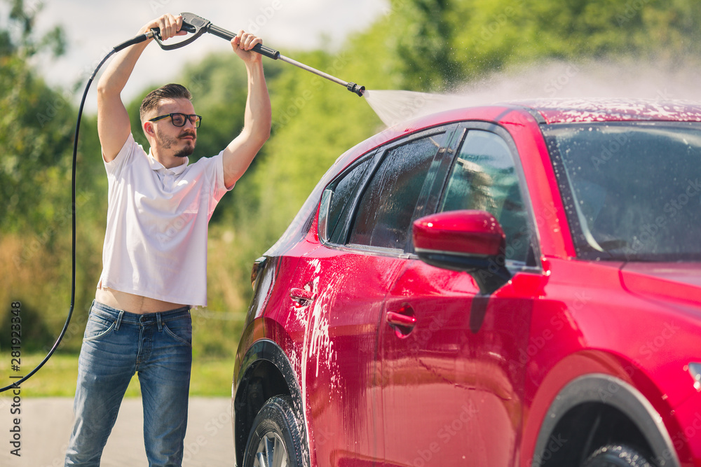 Stockfoto Manual car wash with pressurized water in car wash outside
