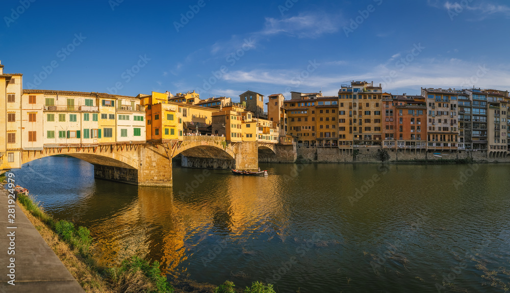 Fototapeta premium Ponte Vecchio bridge over Arno river in Florence city, Italy in the sunset