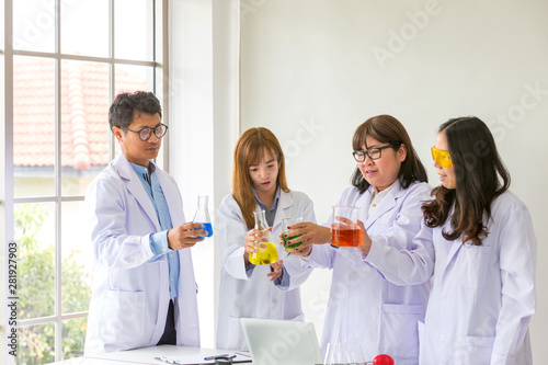 Science Test. Chemist scientific testing quality. Group Scientist working at laboratory. One Man and Three woman at chemistry lab. Asian people. Life scientist researching in laboratory