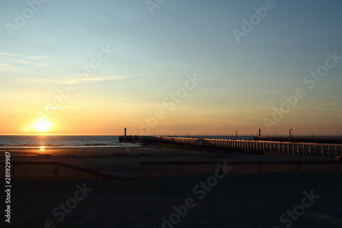 Nieuwpoort in Belgium. Pier and harbor entrance at sunset.