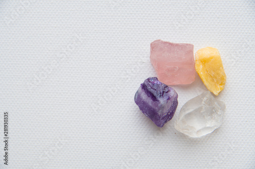 set of semiprecious stones on a white background, on a white textured canvas.