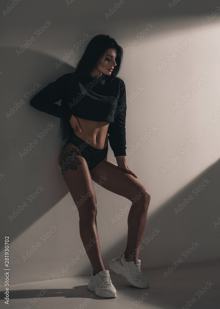 Sexy hot woman in lingerie and sneakers posing in studio on black  background. Seductive nude glamour young girl model portrait. Underwear  passion. foto de Stock | Adobe Stock