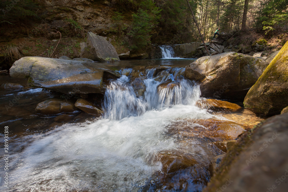Fototapeta premium Small waterfall on a mountain river in Spring