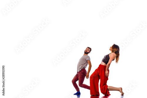 Young couple ballet dancing on white background