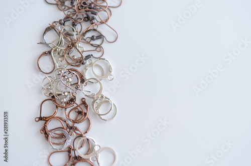 Assorted jewelry making supplies background with space for text.