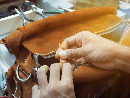 Handmade work Sewing leather bags by hand.