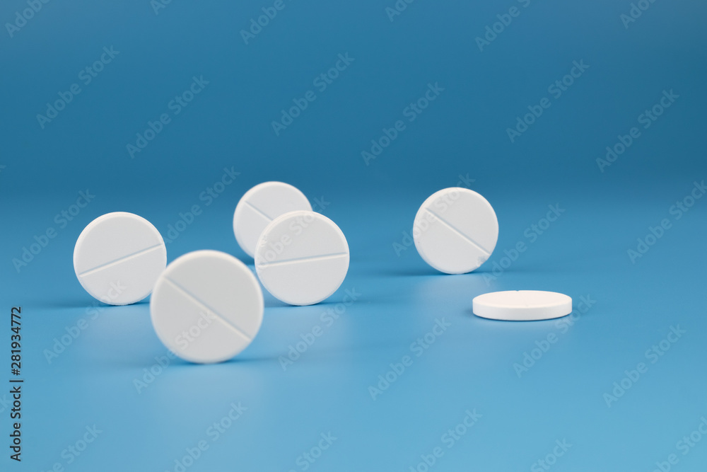 White big pills on a blue background. White big pills on a blue background.