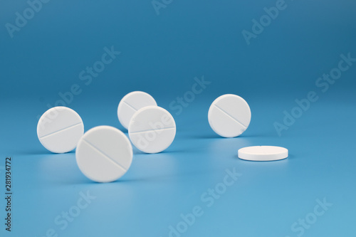 White big pills on a blue background.