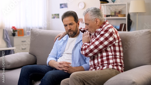 Senior father comforting middle aged son suffering divorce, trustful relations