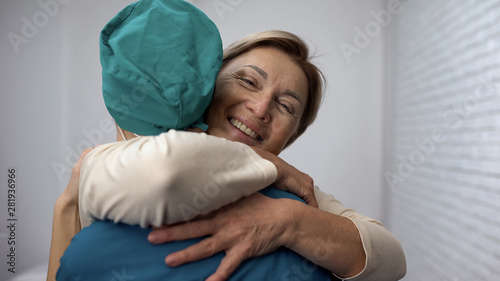 Картината върху платно Happy woman hugging doctor, good test results, recovery and remission, gratitude