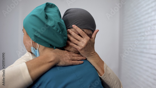 Crying sick female hugging oncologist, no hope, disappointing news, sarcoma