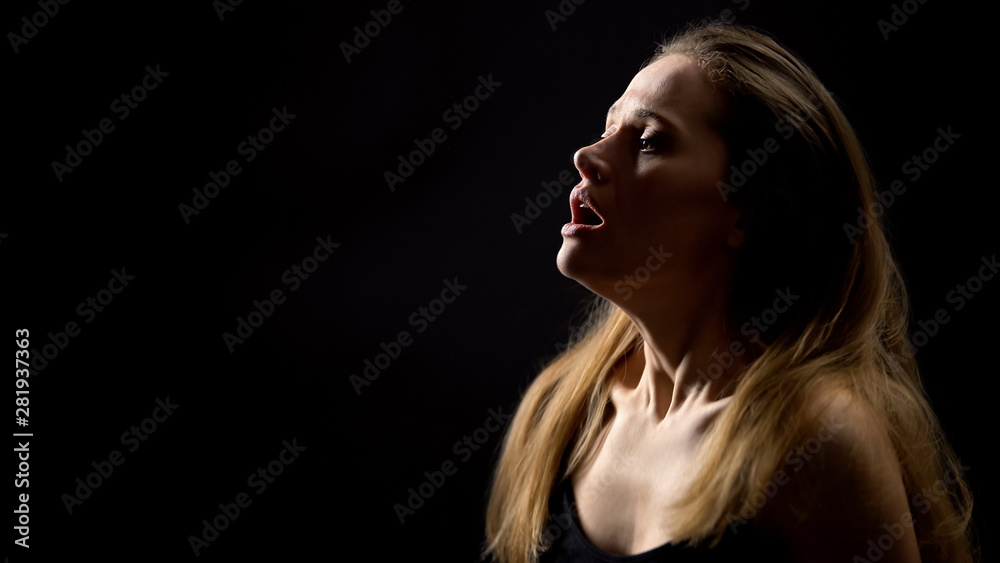 Female hardly breathing, suffering asthma attack, isolated on black background Female hardly breathing, suffering asthma attack, isolated on black background