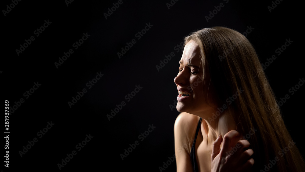 Scared woman fighting with inner fears, psychological disorder, dark background Scared woman fighting with inner fears, psychological disorder, dark background