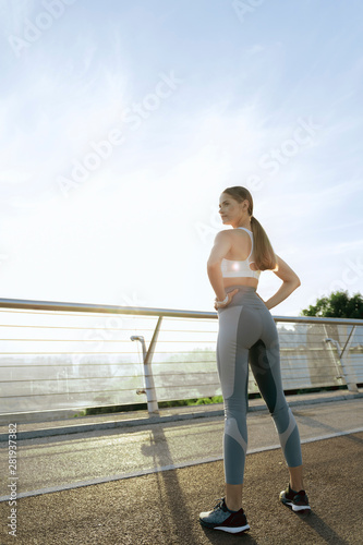 Sportive young lady on morning training outdoor
