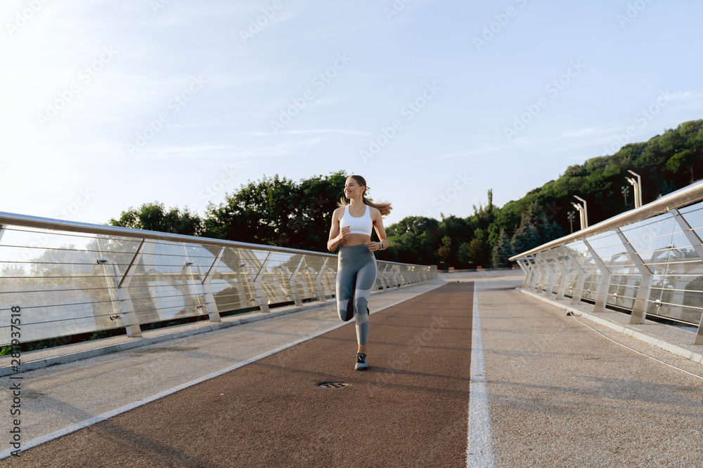 Sportive happy lady on morning training run