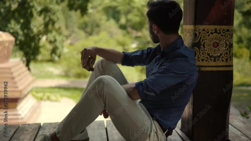 Hungry Businessman Eats Sandwich,Relaxing In Beautiful Place And Enjoying Views.Man Sits And Eating Sandwich.Young Attactive Man Eating Unhealthy Food, Enjoying Dinner. Hungry Businessman Eats Sandwich,Relaxing In Beautiful Place And Enjoying Views.Man Sits And Eating Sandwich.Young Attactive Man Eating Unhealthy Food, Enjoying Dinner.