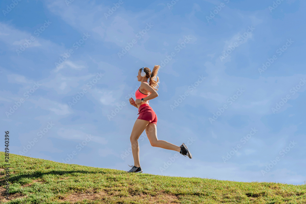 Athletic female have run workout on green hill Athletic female have run workout on green hill