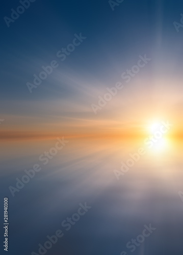 Abstract Beautiful calm sea at sunset with sun and cirrus clouds.