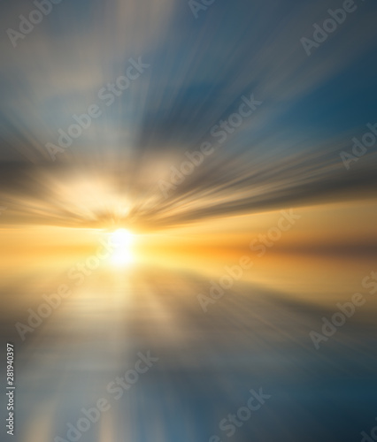 Abstract Sunset on the sea with reflection of clouds and the sun on the water surface.