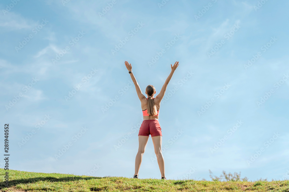 Lady staying on green hill with hands up Lady staying on green hill with hands up