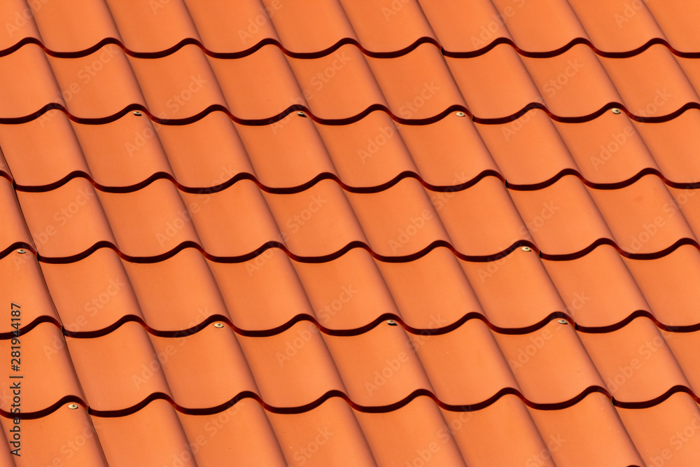 Overlapping rows of red tiles roof in Estonia, ridge tiling material regular pattern background in horizontal orientation. Overlapping rows of red tiles roof in Estonia, ridge tiling material regular pattern background in horizontal orientation.